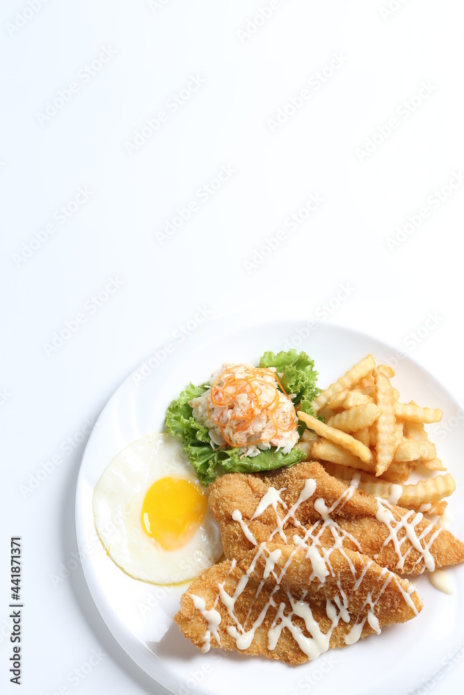 deep fried golden crispy fish fillet and chips with fried egg, French fries, coleslaw salad in tartar sauce western cuisine menu deep fried golden crispy fish fillet and chips with fried egg, French fries, coleslaw salad in tartar sauce western cuisine menu