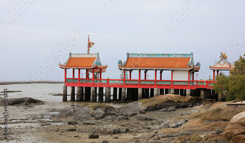 Land mark Red shrine at seaside during low tide at Ang Sri La, Chonburi provice of Thailand photo