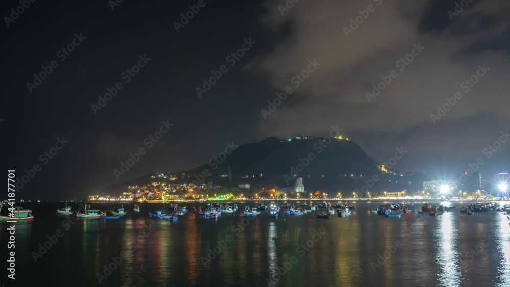 Time lapse sunset and night on a beautiful bay with many fishing boats docked, beautiful night lights for weekend relaxation Time lapse sunset and night on a beautiful bay with many fishing boats docked, beautiful night lights for weekend relaxation