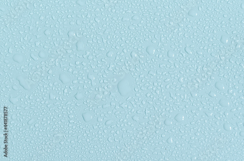 Large and small water drops on the blue background of the mine space. The texture of water drops is a close - up view from above.