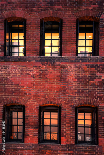 Obraz na plátně Windows in a red brick wall in low key taken in Yokohama red brick area
