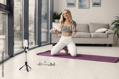 Girl in a sports uniform make yoga at home