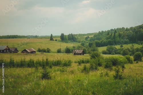 old wooden houses in an abandoned village in the middle of the Russian expanses