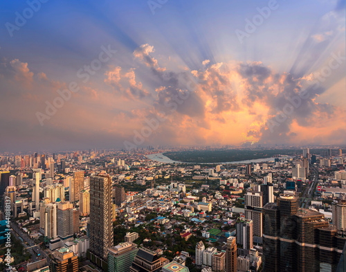 Golden Sunset lightbeam with Bangkok city of cityscape skyline with skyscraper building background in Central business district Bangkok  Thailand