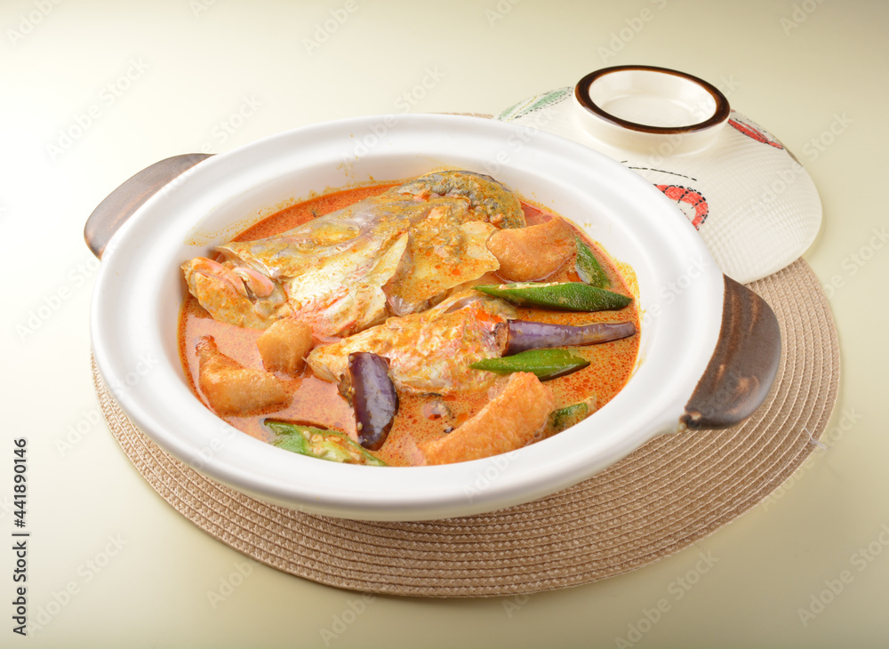 chef cook home style nyonya spicy curry grouper fish head with vegetables in big clay pot chef cook home style nyonya spicy curry grouper fish head with vegetables in big clay pot