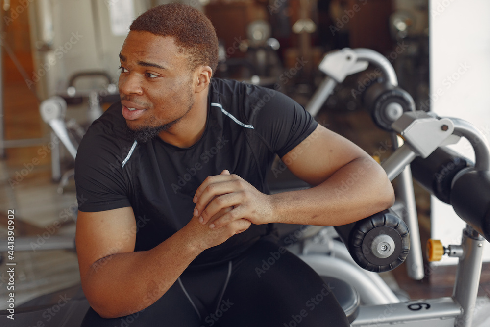 A handsome black man is engaged in a gym A handsome black man is engaged in a gym