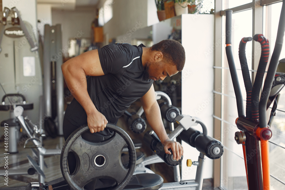 A handsome black man is engaged in a gym A handsome black man is engaged in a gym