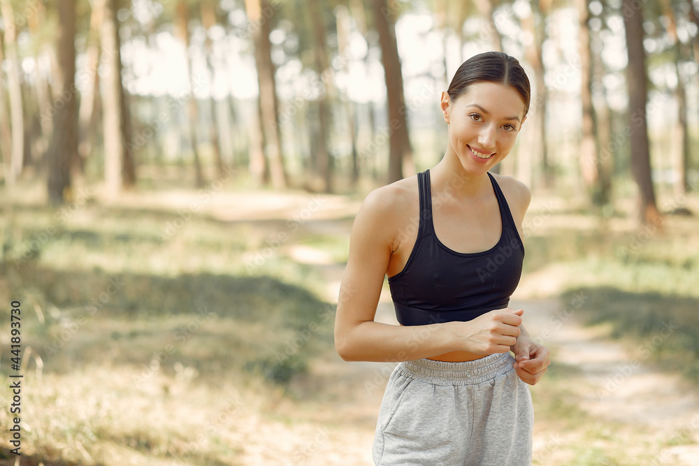 Beautiful woman runs in a summer park Beautiful woman runs in a summer park