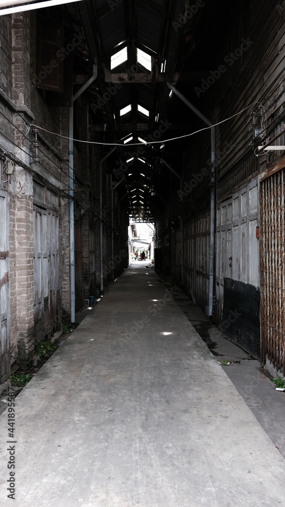 June 16 2021, Minburi, Thailand : Dark narrow alley an old town of Minburi old market, undeveloped area with old buildings.