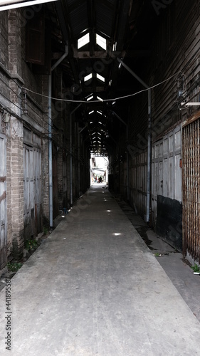 June 16 2021, Minburi, Thailand : Dark narrow alley an old town of Minburi old market, undeveloped area with old buildings.