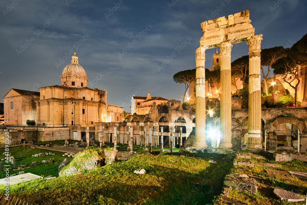 forum romanum in Rome, Italy. Temple of Saturn and Temple of Castor and Pollux, ancient ruins of the Roman Forum in the night. Travel and vacation in Italy
