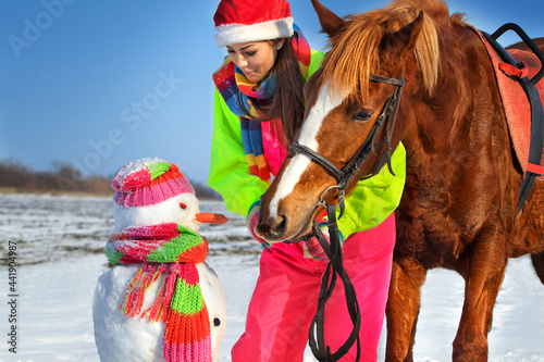 Girl, horse and snowman