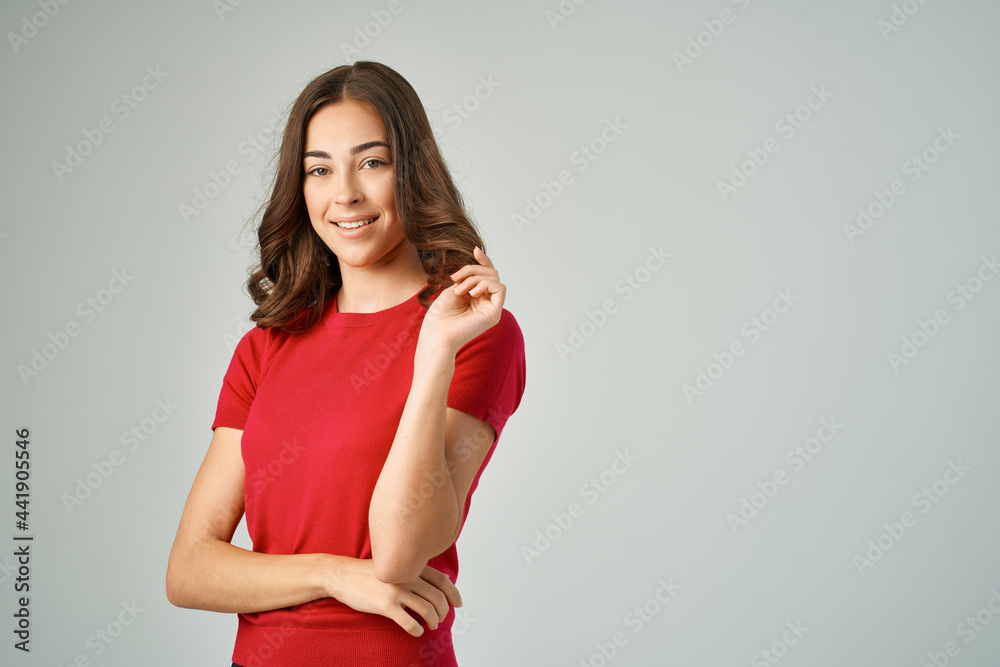 cheerful brunette holding her hair red t-shirt posing studio cheerful brunette holding her hair red t-shirt posing studio