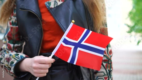 Wallpaper Mural Unrecognizable woman holding Norwegian flag. Girl walking down street with national flag of Norway Torontodigital.ca