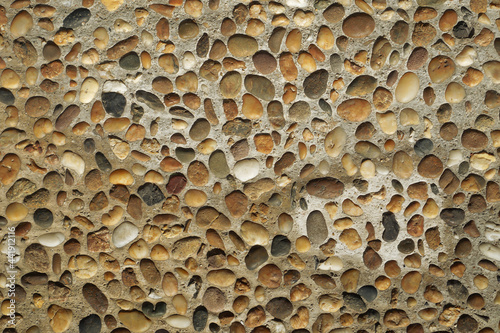 Pebble texture on cement.Background of pebbles. Multicolored pebbles