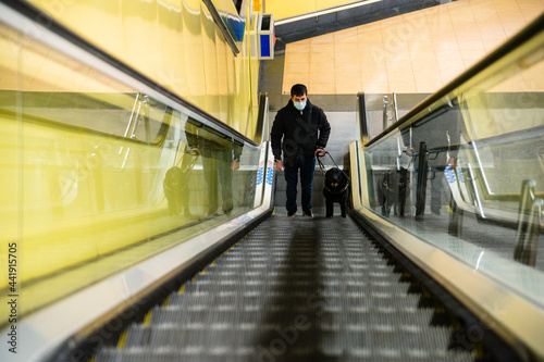 Wallpaper Mural Blind man walking on escalator with guide dog Torontodigital.ca