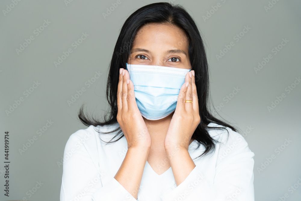 Woman under face mask covering mouth and nose. Corona Virus or COVID-19 concept. Woman under face mask covering mouth and nose. Corona Virus or COVID-19 concept.