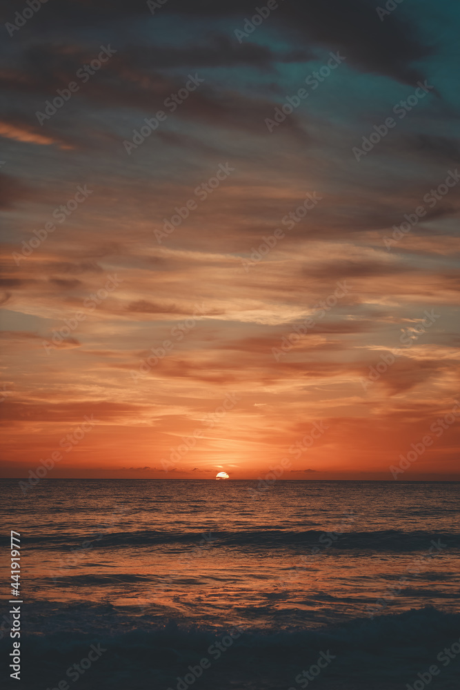 A sunrise over a beach.