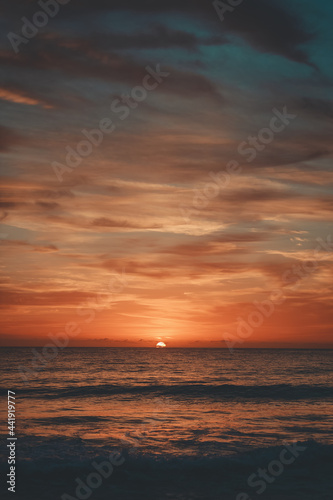 A sunrise over a beach. © Brayden