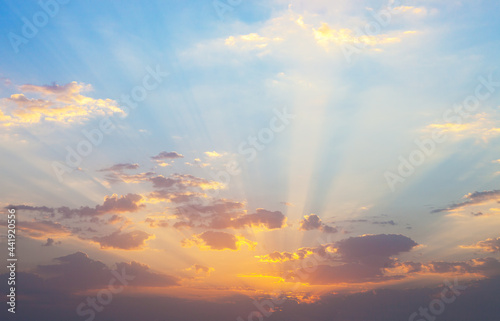 Sunrise with clouds illuminated by the rays of the sun.