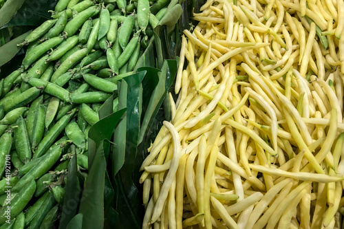 Fresh green peas and butter beans piled on the market. Food background. Harvest