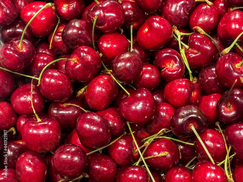 Fresh ripe cherries piled on the market. Food background. Harvest
