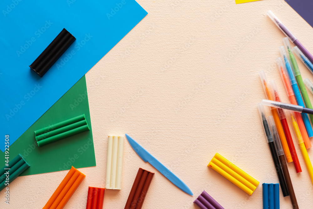 A set for children's creativity and development. Plasticine, felt-tip pens, colored paper on the table. Place for your text A set for children's creativity and development. Plasticine, felt-tip pens, colored paper on the table. Place for your text