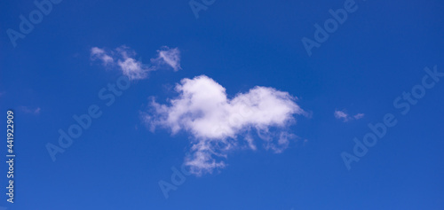 fluffy white clouds on blue sky background The beauty of the sky. Brightness. Suitable for backdrop.