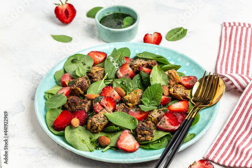 Strawberry salad with chicken liver  spinach  almond and mint. Ketogenic diet dinner  Keto paleo lunch. Food recipe background. Close up