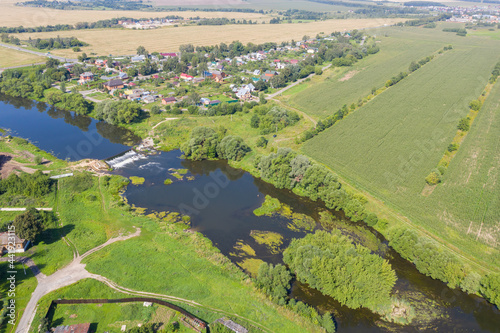 Rural landscape. Aerial view of the dam on Osetr river at sunny day. Zaraysk, Moscow Oblast, Russia.