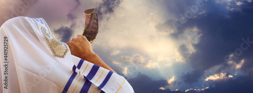 Jewish man blowing the Shofar (horn) of Rosh Hashanah (New Year). Religious symbol