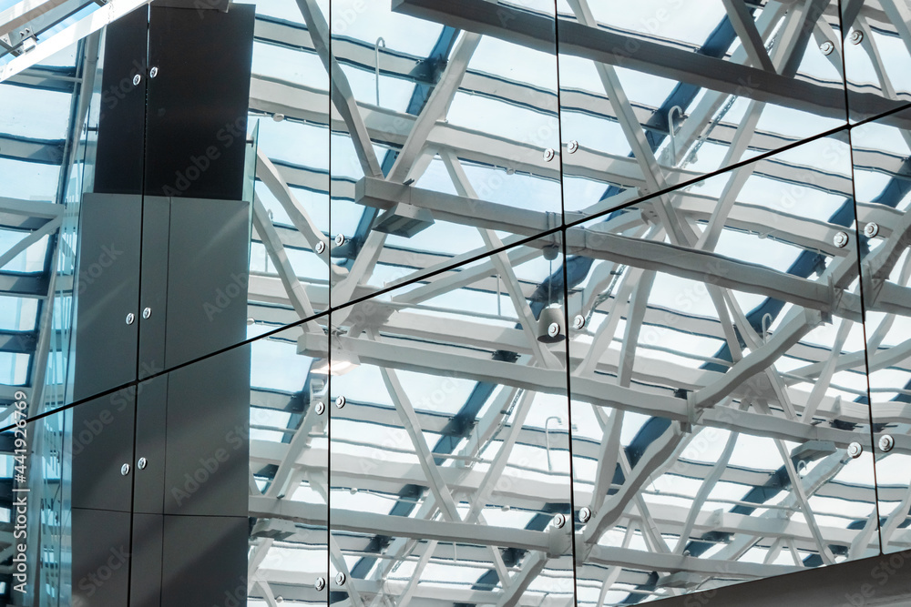 Transparent glass ceiling, Abstract metal structure. Ceiling with crossed metal beams. Metal roof with windows.