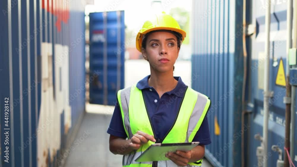 african american foreman woman using tablet computer walking to checking and control loading Containers box at warehouse logistic in Cargo . import export freight ship . black worker transportation african american foreman woman using tablet computer walking to checking and control loading Containers box at warehouse logistic in Cargo . import export freight ship . black worker transportation