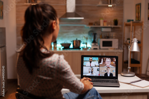 Businesswoman having a video conference with clients at midnight from home. Corporate meeting using modern technology, laptop late at night , tech, agency, advisor, work, discussion.