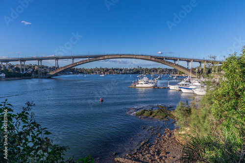 Panorama view of Gladesville Bridge Parramatta river on Sydney harbour foreshore NSW Australia. Boats Yachts and ferry with luxury houses on the bay