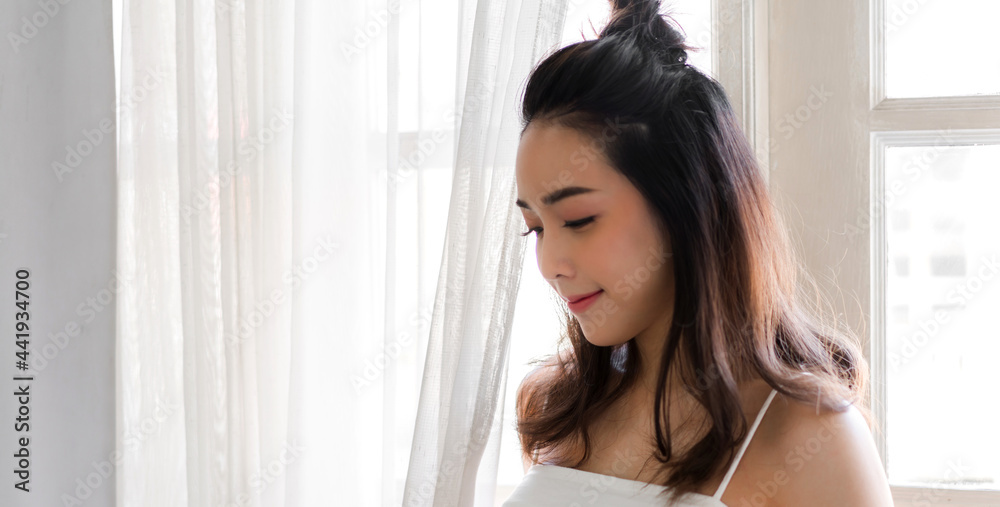 Portrait of smiling cheerful beautiful pretty asian woman clean fresh healthy white skin posing in white clothes.Girl felling relaxing and enjoy time in banner at home.asia beauty Portrait of smiling cheerful beautiful pretty asian woman clean fresh healthy white skin posing in white clothes.Girl felling relaxing and enjoy time in banner at home.asia beauty