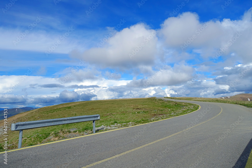 Fototapeta premium Beautiful scenic view in a rainy and cloudy day over the Transalpina road, the highest mountain road in the Carpathians located in the Parang mountains, Romania, Europe