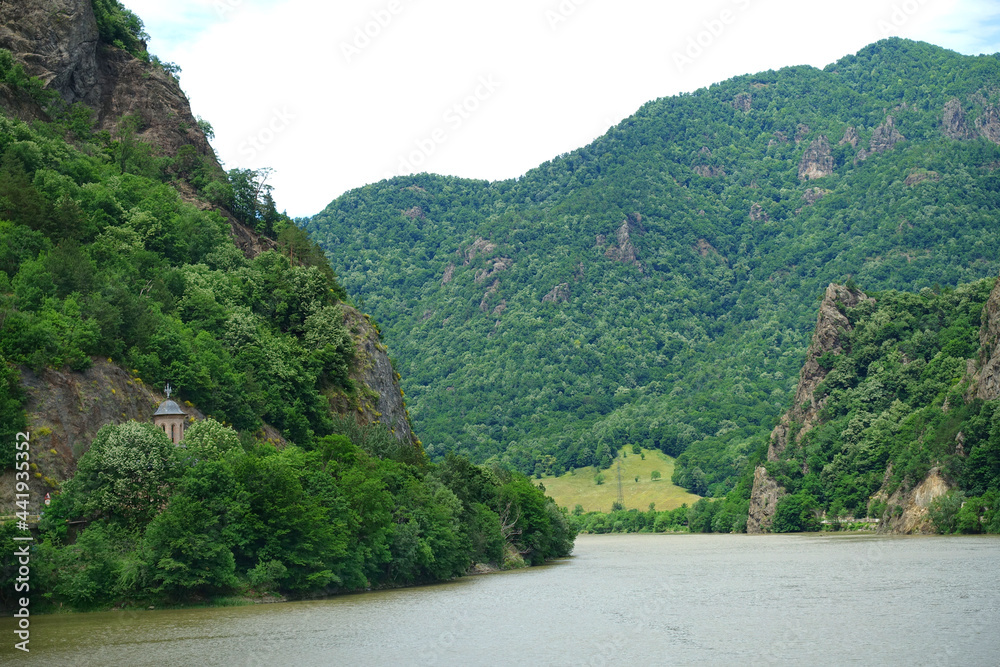 Landscape of Olt Valley with Olt river and Cozia Mountains in Romania
