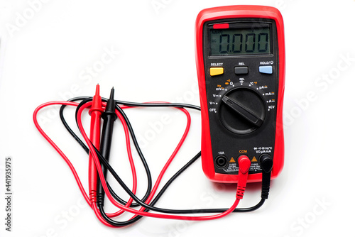 Electronic digital multimeter isolated on white with probes. Digital multimeter with red and black leads. Electronic multimeter isolated on white background close up photo