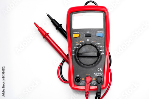 Foto Electronic digital multimeter isolated on white with probes