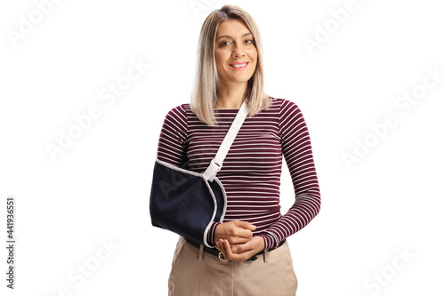 Young woman with a broken arm wearing an arm splint smiling at camera photo