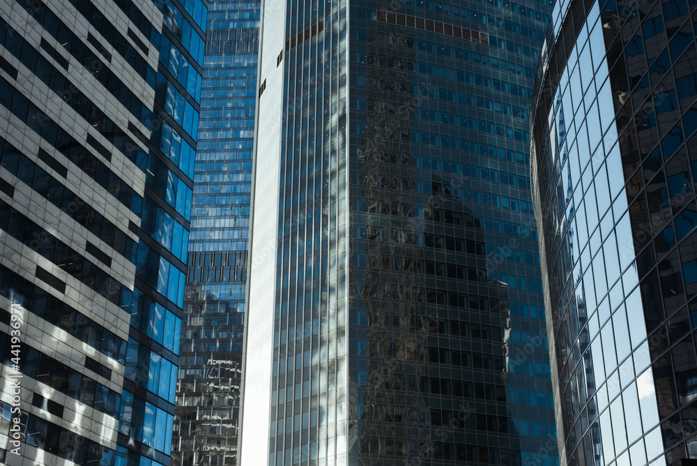Business district of the city. Modern office building exterior. Close up of skyscrapers outside. Finance and business concept Business district of the city. Modern office building exterior. Close up of skyscrapers outside. Finance and business concept