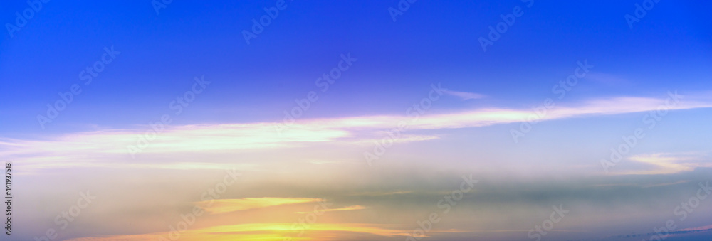 Beautiful sky with clouds at sunset, panoramic big shot. Background from the cloudy sky. Long and stretched clouds in the sky. Blue sky with long clouds for background.