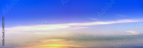 Beautiful sky with clouds at sunset, panoramic big shot. Background from the cloudy sky. Long and stretched clouds in the sky. Blue sky with long clouds for background. © ArturSniezhyn