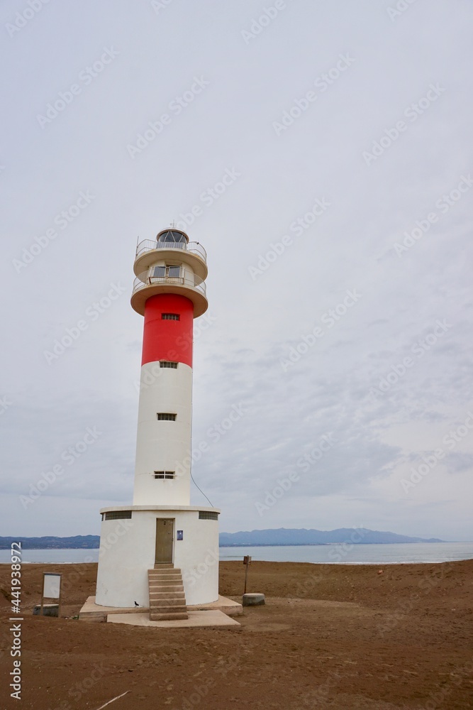 Delta del Ebro. Tarragona. Spain. 06/20/2021.  lighthouse with people and sand and blue sky