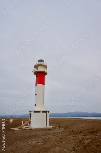 Delta del Ebro. Tarragona. Spain. 06 20 2021.  lighthouse with people and sand and blue sky