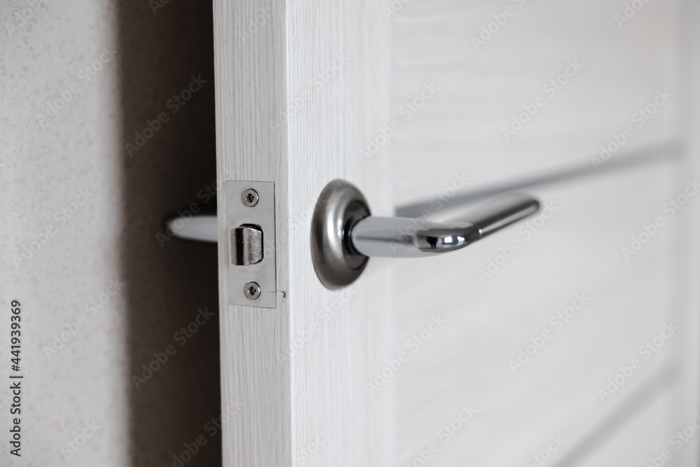 New interior doors close-up. the handle on the door is silver. the concept of renovation and design of the apartment New interior doors close-up. the handle on the door is silver. the concept of renovation and design of the apartment