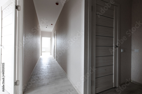 Modern white minimalist interior blank wall. The corridor in the apartment. bright inter-apartment doors.