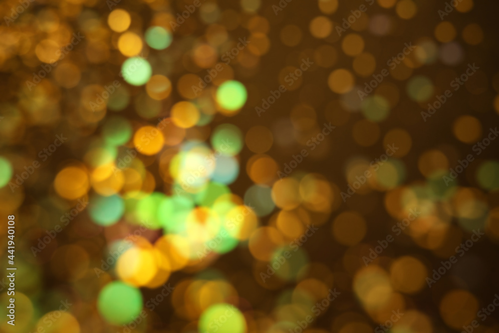 Naklejka premium Blurred view of shiny lights on dark background. Bokeh effect