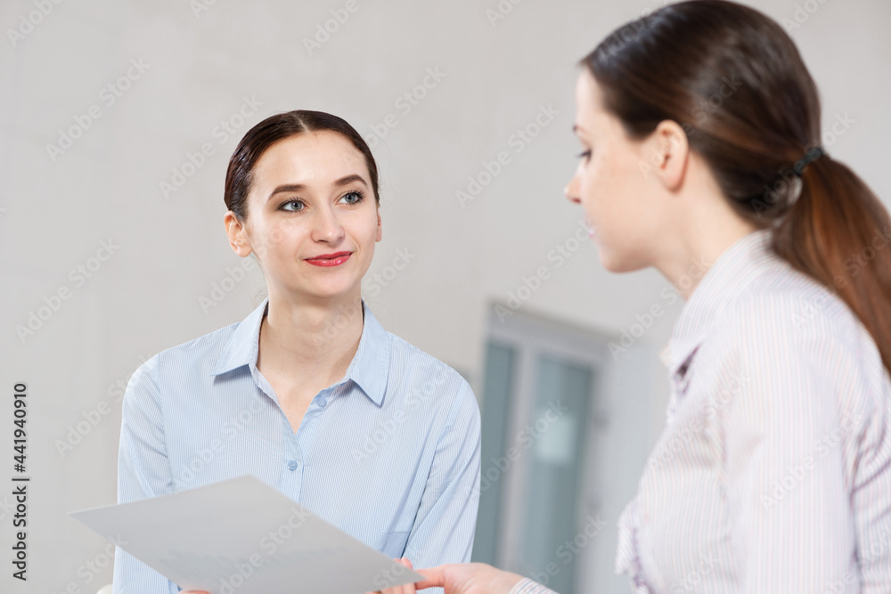 Young attractive woman talks to a colleague in the office Young attractive woman talks to a colleague in the office
